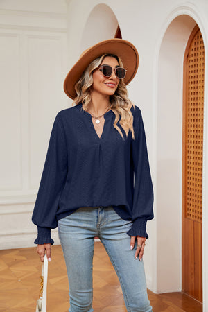 Navy eyelet detail blouse with V-neck and poet sleeves with smocked cuffs.