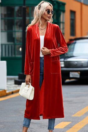 Deep Red velvet duster coat with pockets, open front, long sleeves, and a flowing silhouette.