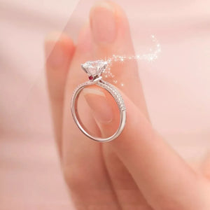 Sterling silver ring with moissanite diamond and small red accent stone