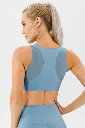 Light blue performance sports bra with mesh back panels and racerback detail.