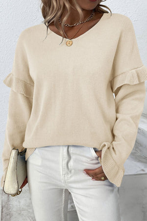 Light yellow knit pullover sweater with ruffled sleeves and V-neck.