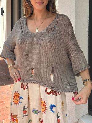 Distressed taupe knit pullover with cutout details and a scooped neckline.