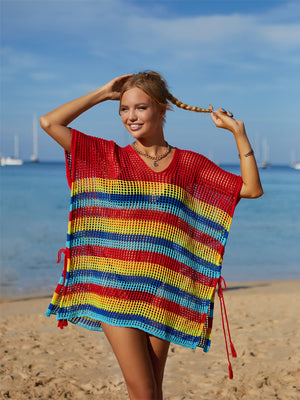 Rainbow stripe crochet beach poncho with V-neck and drawstring sides.