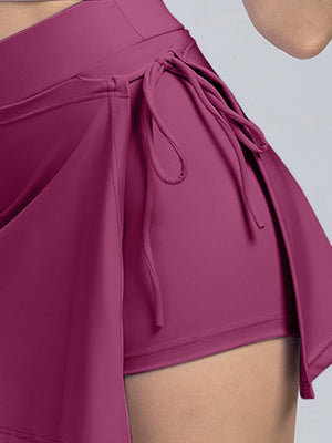 Deep purple skort with wrap detail and side tie closure.