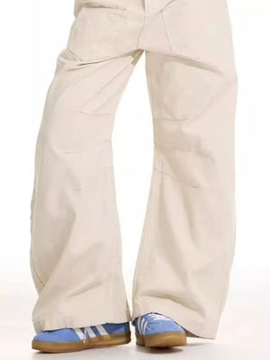 Men's beige cotton wide-leg sweatpants with panel details.