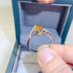 Silver ring with yellow diamond and pave accents, swirl design