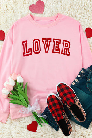 Pink drop shoulder sweatshirt with red "Lover" graphic.