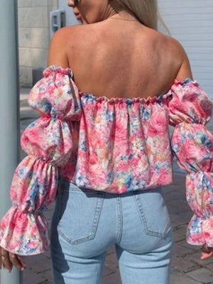 Off-the-shoulder blouse with ruffle sleeves and a floral print in pink and blue.