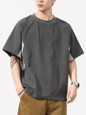 Men's dark gray textured t-shirt with contrast panels and crew neck.