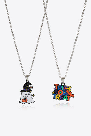 Spooky Season Enamel Pendant Set necklaces, one with a ghost and pumpkin, one with Trick or Treat text.