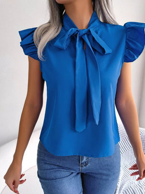 Royal blue pussy-bow blouse with ruffle cap sleeves and tie detail.