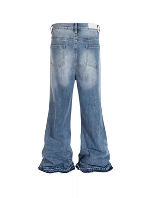 Distressed baggy fit men's jeans in light blue denim with wide legs and frayed hems.