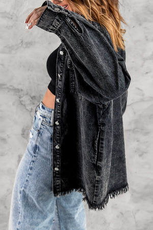 Black oversized denim shirt jacket with frayed hem and button front.