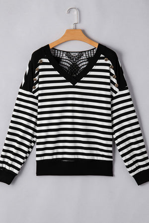 Black and white striped blouse with lace back detail and button accents.