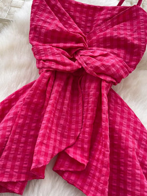 Rose red asymmetrical cami top with a twisted knot detail and gingham pattern.