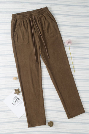 Corduroy drawstring trousers in mocha with slant pockets and a relaxed fit.