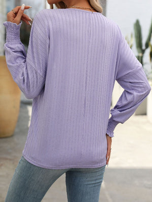 Lilac textured sleeve blouson top with smocked cuffs and a relaxed fit.