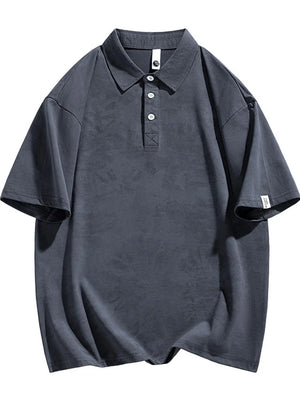 Dark gray cotton polo with subtle texture, buttoned placket, and short sleeves.