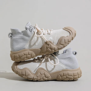 Sculpted knit athleisure sneakers in light grey with tan soles and white laces.