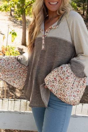 Floral bell sleeve henley top in mocha with button neckline and contrast sleeves.
