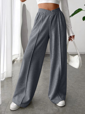 Dark gray V-waistline palazzo sweatpants with center seams and wide legs.