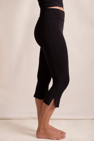 Black flared hem crop leggings with side slits at the hem.