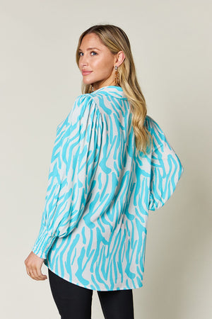 Tiffany Blue zebra print blouse with shirred cuffs and puff sleeves.