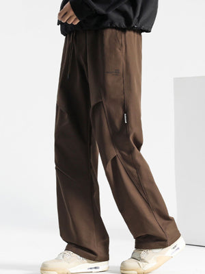 Brown drawstring sweatpants with a relaxed fit and subtle logo detail.