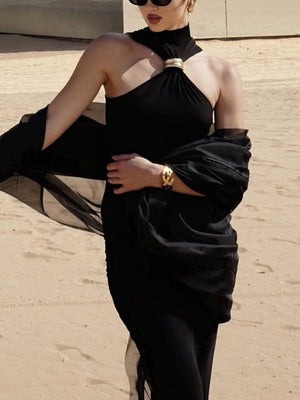 Black asymmetrical halter neck tank top with gold ring detail and sheer draped sleeves.