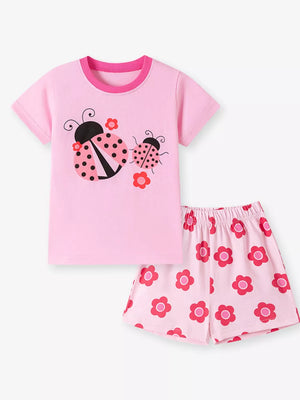 Pink baby girl's short sleeve top and shorts set with ladybug and flower graphics.
