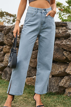 Light wash denim jeans with a straight leg and split hem detail.