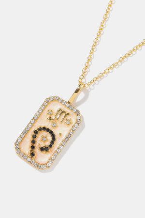 14K gold-plated necklace with a rectangular pendant featuring the Scorpio zodiac sign in black crystals and gold accents.