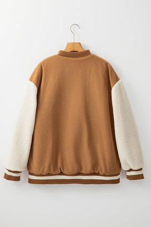 Brown corduroy bomber jacket with sherpa sleeves and striped ribbing.