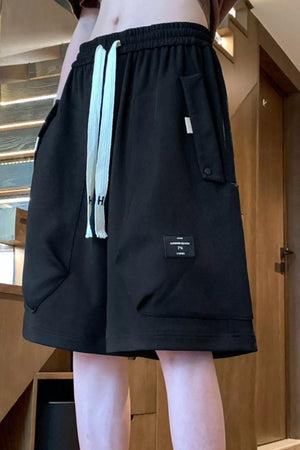 Black relaxed fit chino shorts with drawstring and pocket details.