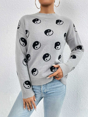 Heather gray knit sweater with all-over black yin yang pattern, drop shoulders, and crew neck.