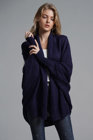 Dark blue acrylic cocoon knit sleeve cardigan with open front and ribbed cuffs.