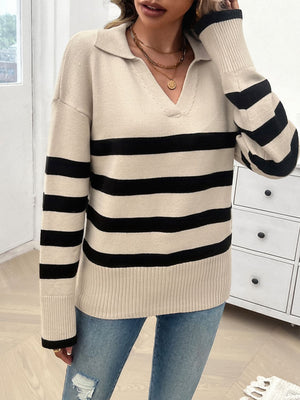Tan knit polo sweater with bold black stripes and a v-neck.
