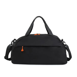 Black duffel bag with orange zipper accents and detachable strap