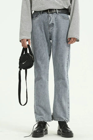 Medium wash acid wash denim jeans with a straight leg cut and split hem detail.