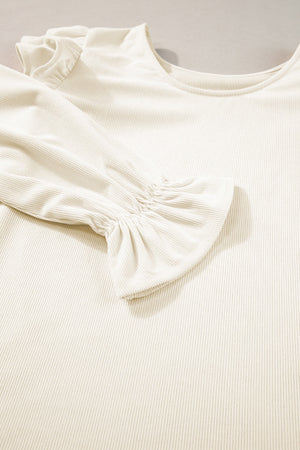 Textured ruffle sleeve blouse in eggshell with ribbed fabric and a scoop neckline.