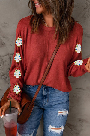 Scarlet sweater with embellished Christmas trees on sleeves.