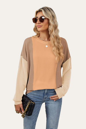 Colorblock waffle knit pullover sweater in tan, peach, and beige with crew neck and long sleeves.