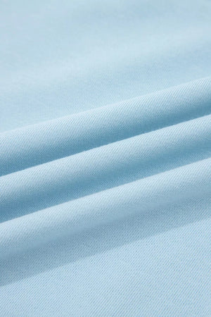 Light blue cotton bikini fabric with textured weave and soft folds.