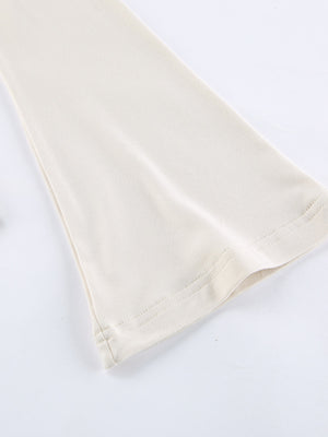 Beige long-sleeve shirt with knot front and cutout detail.