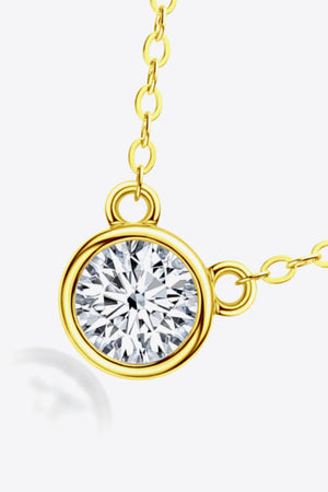 Gold solitaire moissanite bezel necklace with delicate chain.