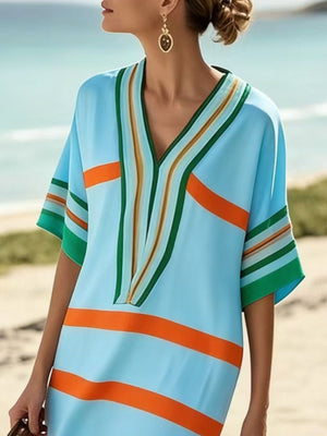 Striped half sleeve midi dress in pastel blue with orange and green stripes.