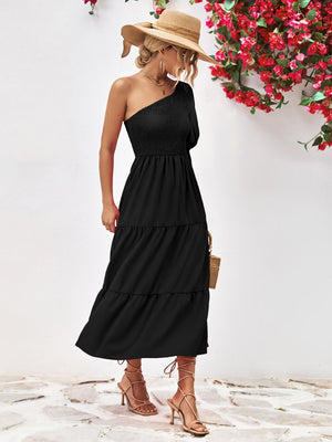 Black smocked bodice one-shoulder tiered midi dress with a flowy skirt.