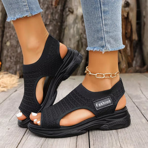 Black sporty chunky platform sandals with breathable knit uppers and a white "Fashion" label.