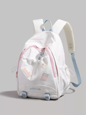 White drawstring backpack with pink accents and cute patches, adjustable blue straps
