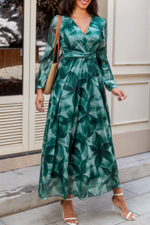 V-neck wrap maxi dress in green botanical print with long sleeves and a tie waist.